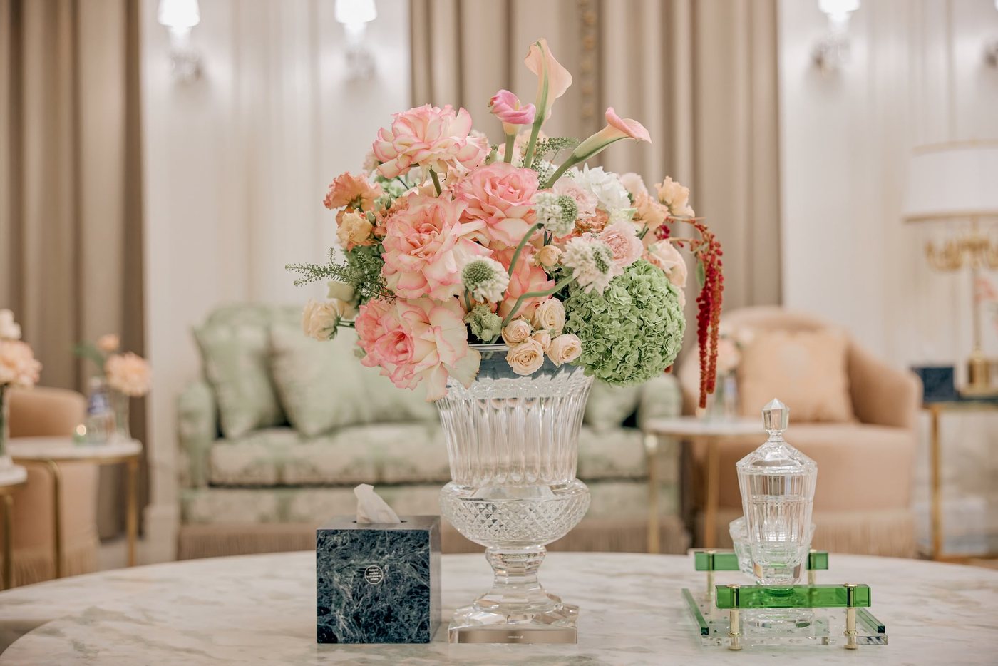 Cropped real project floral and marble table detail used only as a finishing-touch accent